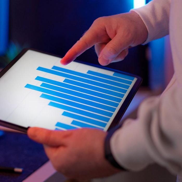 Owner checking sales charts on a tablet